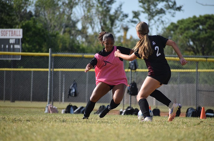 Sophomore midfielder Jordynn Roberts (left) aims for the ball at the feet of freshman defender Caroline Foster (right) during an Oct. 23 practice. After scoring 16 goals in her first year with Braden River, Roberts is back for more.