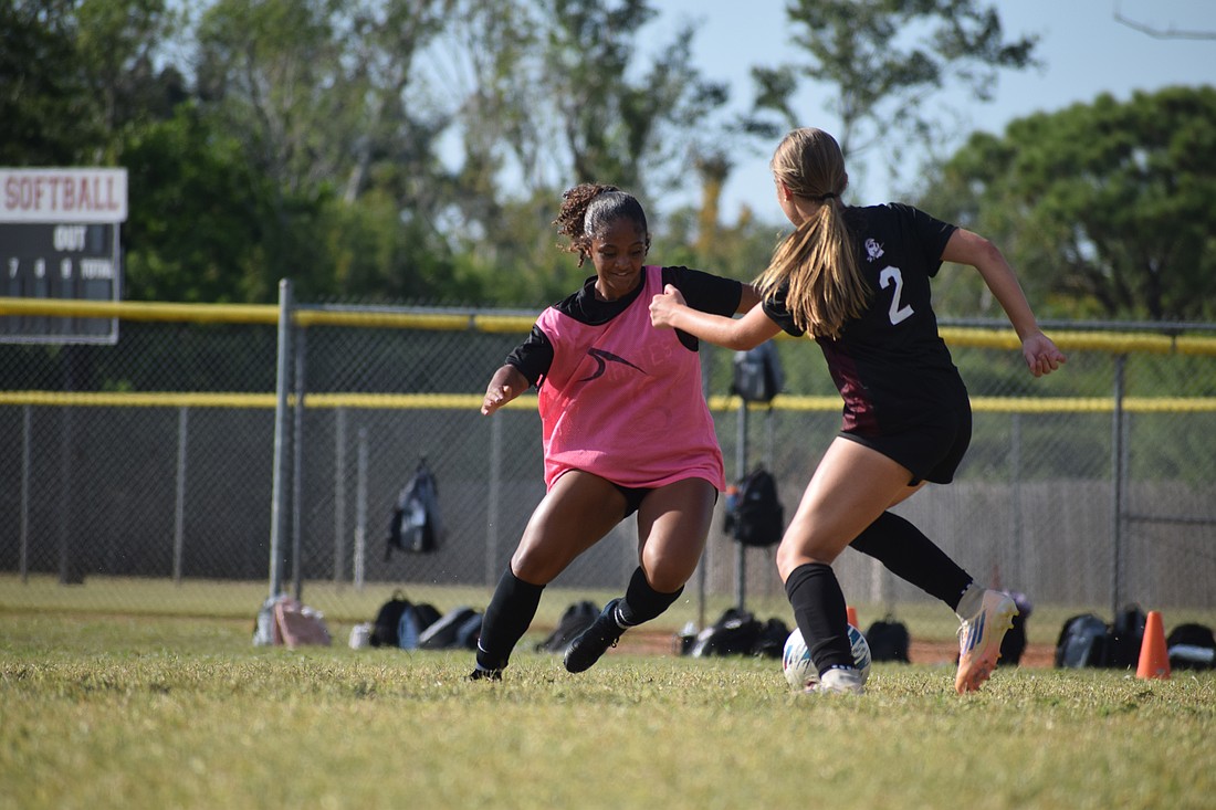 Sophomore midfielder Jordynn Roberts (left) aims for the ball at the feet of freshman defender Caroline Foster (right) during an Oct. 23 practice. After scoring 16 goals in her first year with Braden River, Roberts is back for more.