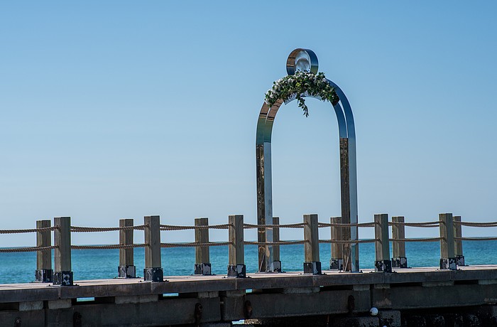 St. Regis Longboat Key Resort added faux flora atop letters of its arch while the hotel and town work on a solution to bring the sign into code compliance, or vise versa.