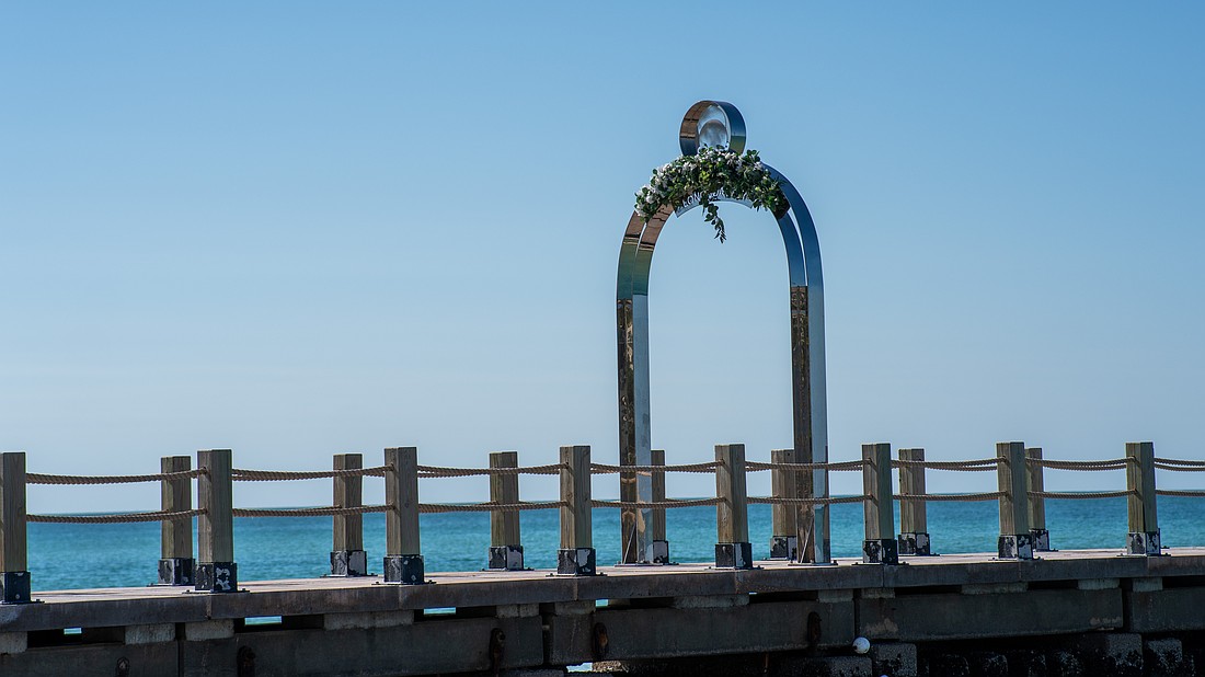 St. Regis Longboat Key Resort added faux flora atop letters of its arch while the hotel and town work on a solution to bring the sign into code compliance, or vise versa.