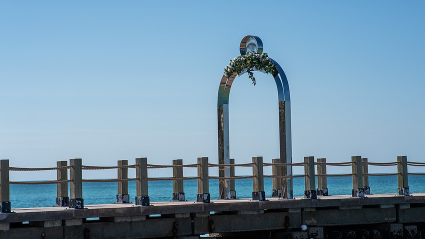 St. Regis Longboat Key Resort added faux flora atop letters of its arch while the hotel and town work on a solution to bring the sign into code compliance, or vise versa.