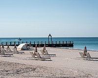 St. Regis Longboat Key Resort installed a stainless steel metal arch on a converted groin extending into the Gulf. Longboat Key town staff asked the hotel to take the arch down because it does not follow town code.