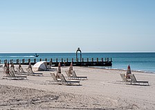 St. Regis Longboat Key Resort installed a stainless steel metal arch on a converted groin extending into the Gulf. Longboat Key town staff asked the hotel to take the arch down because it does not follow town code.