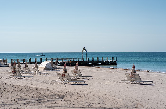 St. Regis Longboat Key Resort installed a stainless steel metal arch on a converted groin extending into the Gulf. Longboat Key town staff asked the hotel to take the arch down because it does not follow town code.