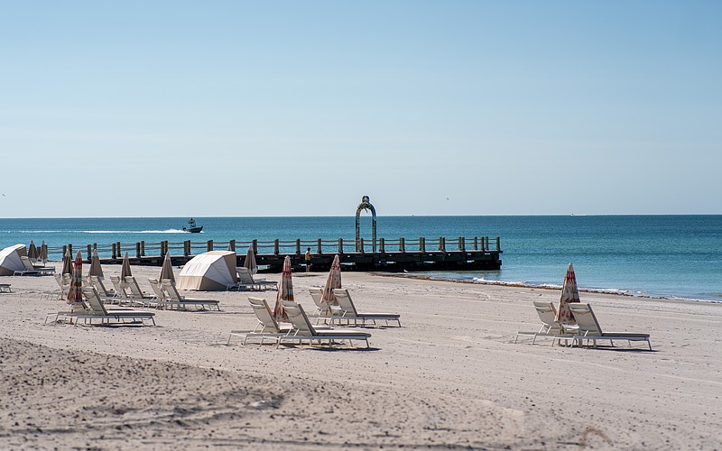 St. Regis Longboat Key Resort installed a stainless steel metal arch on a converted groin extending into the Gulf. Longboat Key town staff asked the hotel to take the arch down because it does not follow town code.