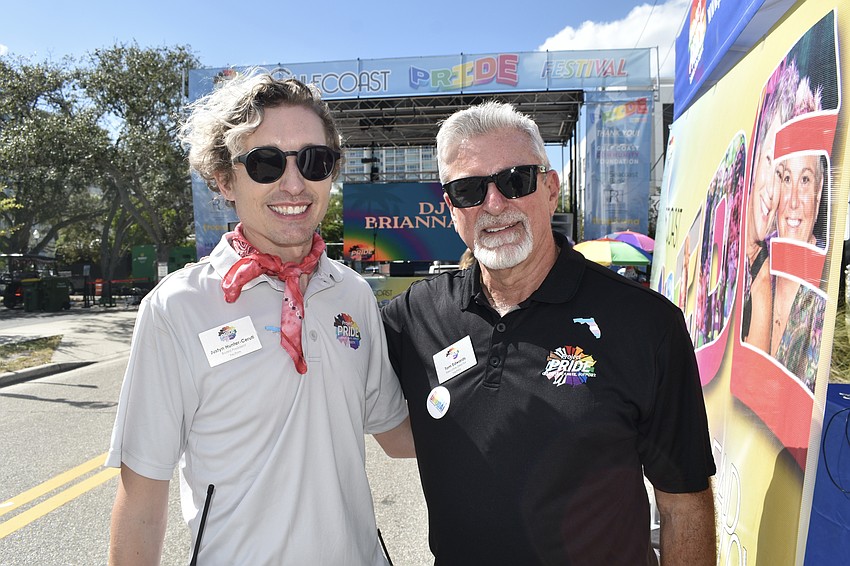 Board president Justyn Hunter-Ceruti and Executive Director Tom Edwards stand near the event stage.