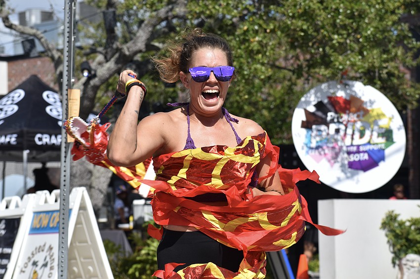 Kay Mount gets a little tangled in the banner, but is having fun anyway.