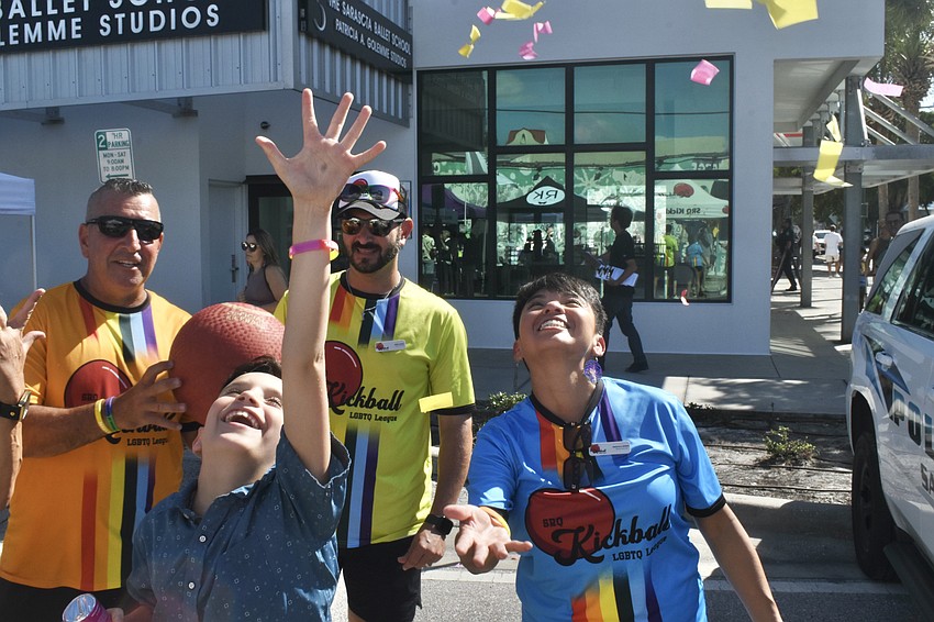 Adam Feliciano, 10, throws confetti into the air, standing in front of John Hutchinson, Greg Cadili and his parent Priscilla Gomez.