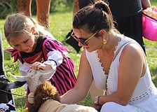 Lakewood Ranch 5-year-old Cora Forrester and her mom Cassie Campbell give some love to Banjo the goat from Blissful Goat Yoga during East Manatee Fire Rescue's Trunk or Treat Oct. 25.