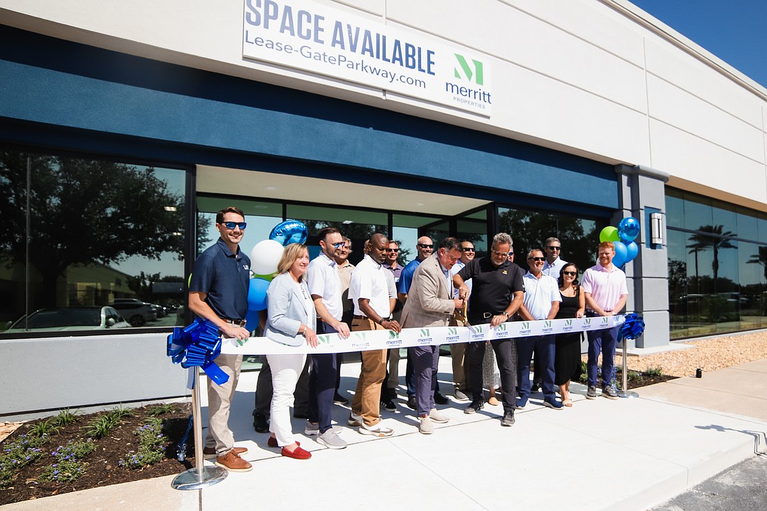 Patrick Franklin, Florida regional director of Merritt Properties, cut the ribbon Oct. 22 marking the completion of the first phase of redevelopment of the Merritt at Gate Parkway light industrial park in South Jacksonville.