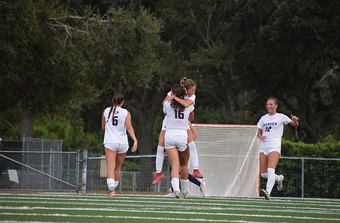 Senior midfielder Sofia Sepulveda (10) embraces junior midfielder Emily Simone (16), with junior midfielder Colette Maute (6) and sophomore midfielder Mia Alexander (12) joining in on the celebration. Riverview girls' soccer enters the 2025-26 season as back-to-back district champions.