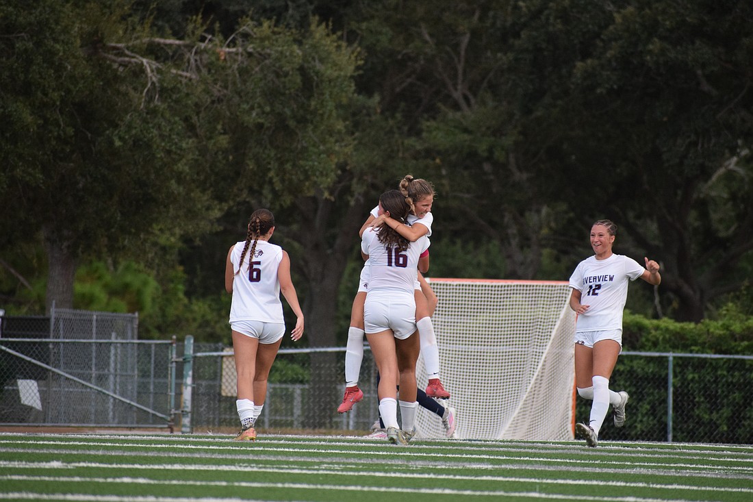 Senior midfielder Sofia Sepulveda (10) embraces junior midfielder Emily Simone (16), with junior midfielder Colette Maute (6) and sophomore midfielder Mia Alexander (12) joining in on the celebration. Riverview girls' soccer enters the 2025-26 season as back-to-back district champions.