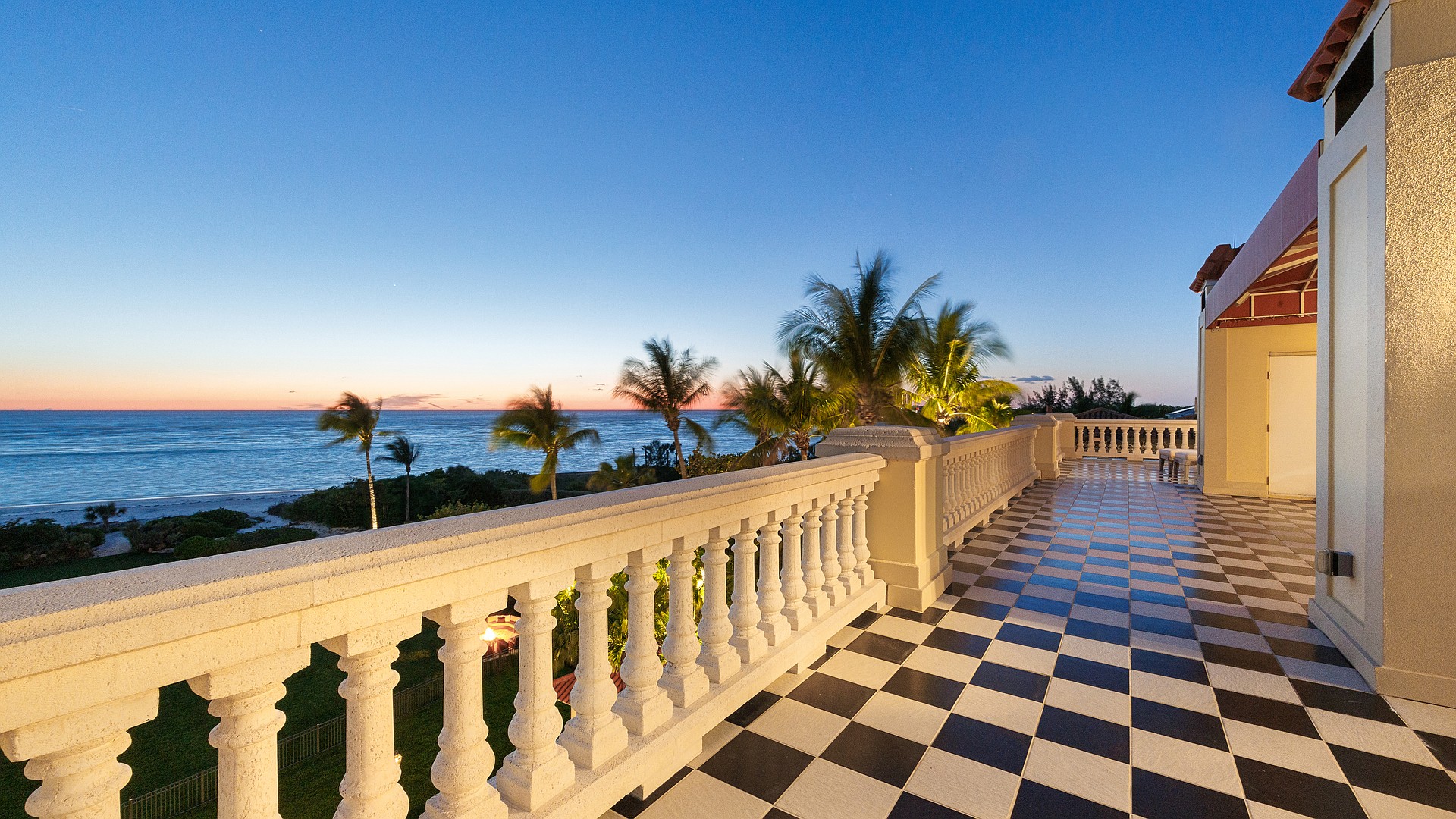 The best view in town. Sunset from the rooftop terrace of this Lido Shores mansion.