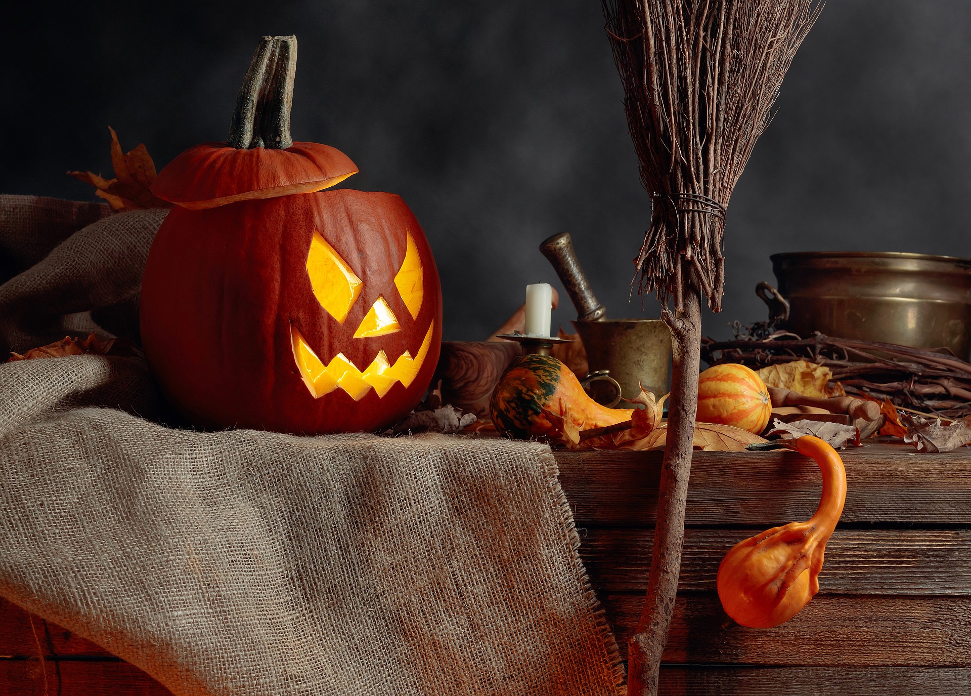 Halloween pumpkins on a old wooden background. Conceptual still life on the theme of Halloween. Copy space.
