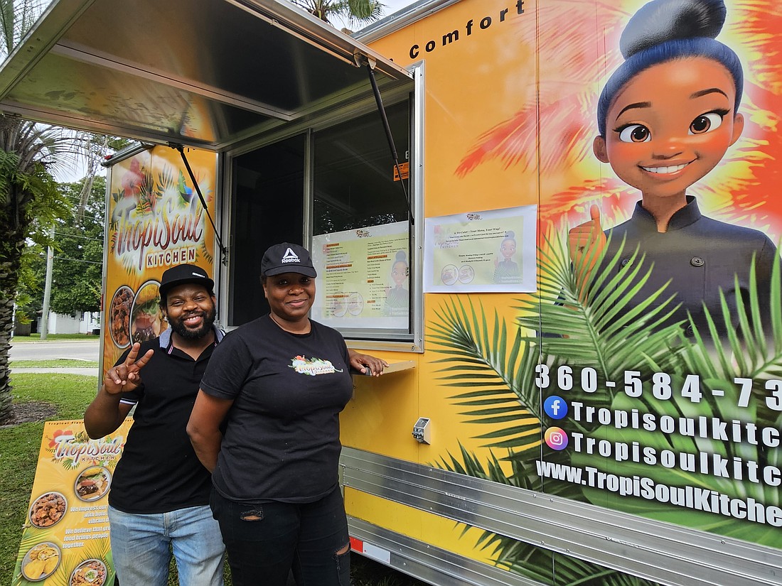 TropiSoul Kitchen is one of a few food trucks out of Palm Coast that has to operate outside of the city because of Palm Coast's strict food truck regulation. Pictured: Enock Elisme and his wife Carty Caprice. Photo by Sierra Williams