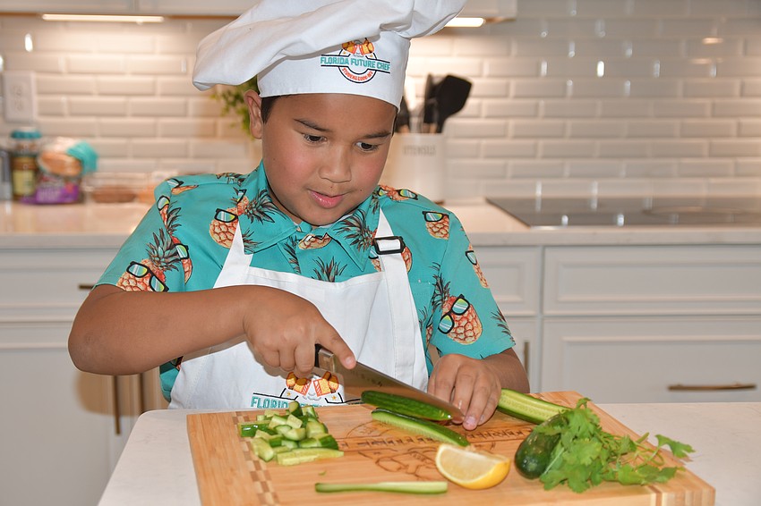 Lincoln Emery showed off his chopping skills in the kitchen.