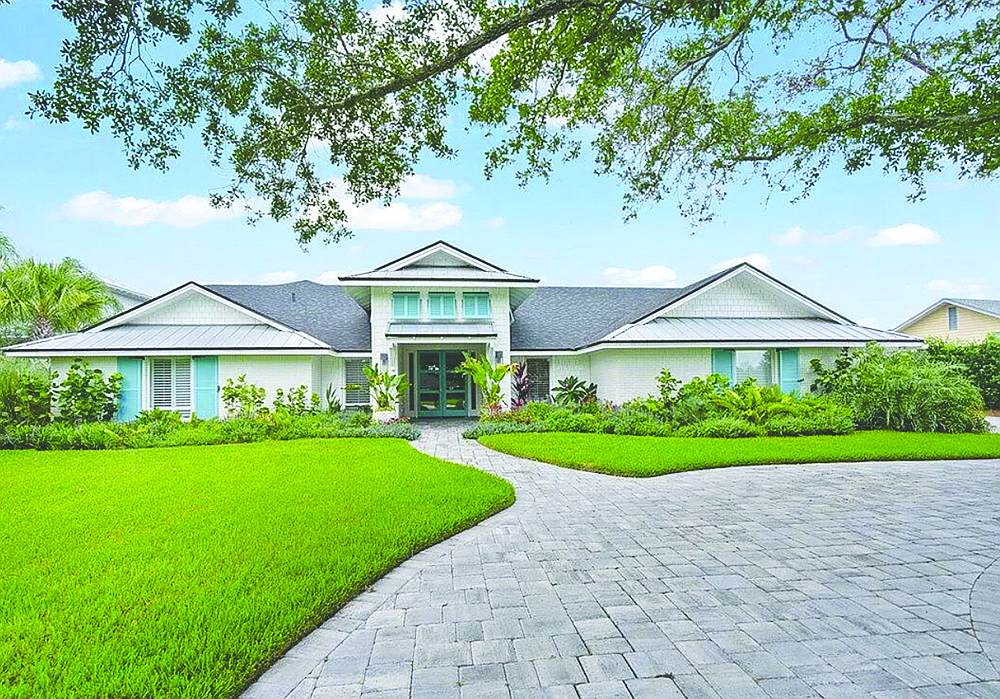 Waterfront home features five bedrooms, four full and two half-bathrooms, butler pantry, porch, outdoor kitchen, patio, pool and dock.