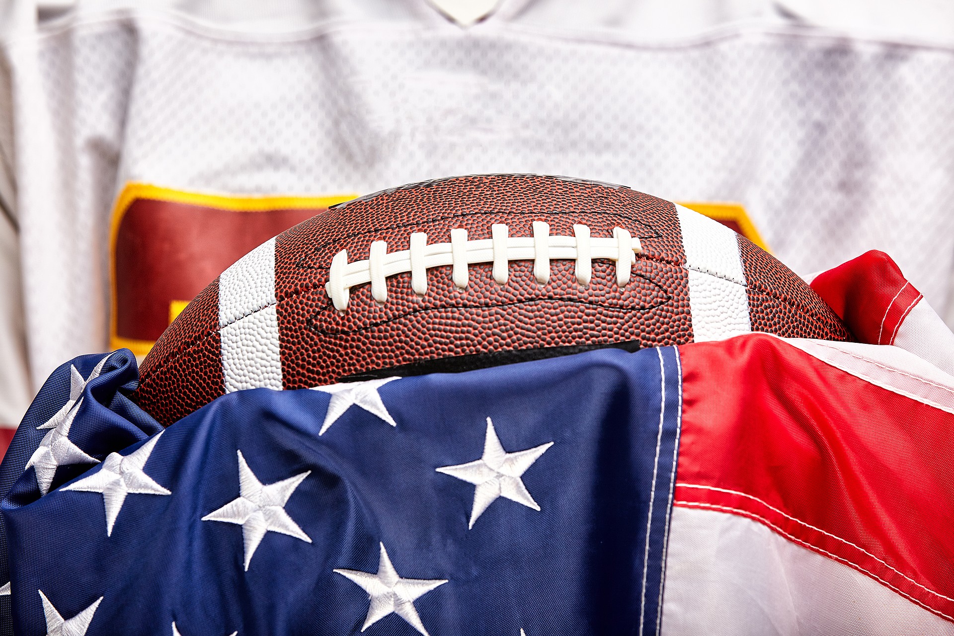 American football concept, ball on american flag background and american football uniform