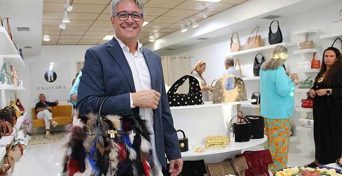 Christian Delunas, retail general manager, shows one of his favorite unique purses offered at the newly opened Italian Idea boutique on St. Armands Circle. The shop recently hosted a soft opening for its third attempt to open a location on the shopping hub.