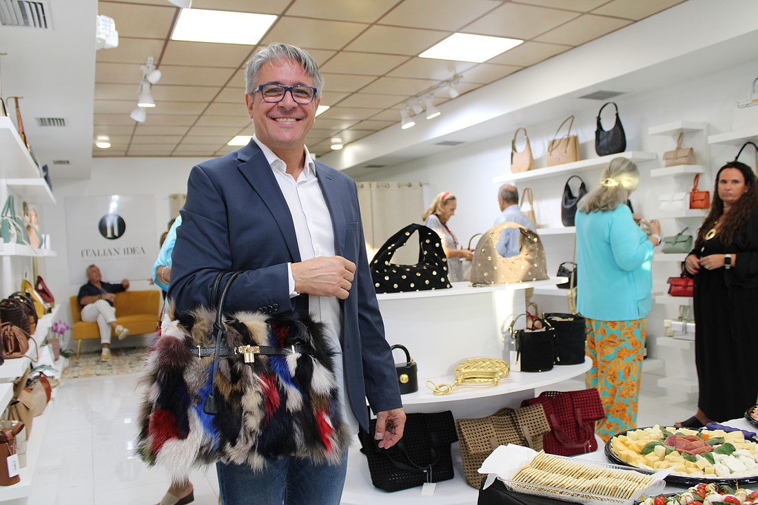 Christian Delunas, retail general manager, shows one of his favorite unique purses offered at the newly opened Italian Idea boutique on St. Armands Circle. The shop recently hosted a soft opening for its third attempt to open a location on the shopping hub.