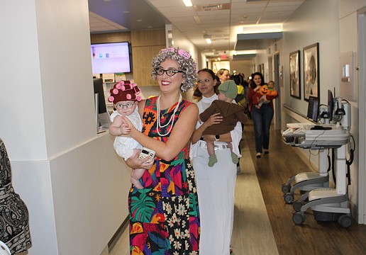 Sweetwater's Monica Zacour and 5-month-old Everly curl through the parade route at Lakewood Ranch Medical Center Oct. 29.