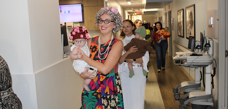 Sweetwater's Monica Zacour and 5-month-old Everly curl through the parade route at Lakewood Ranch Medical Center Oct. 29.