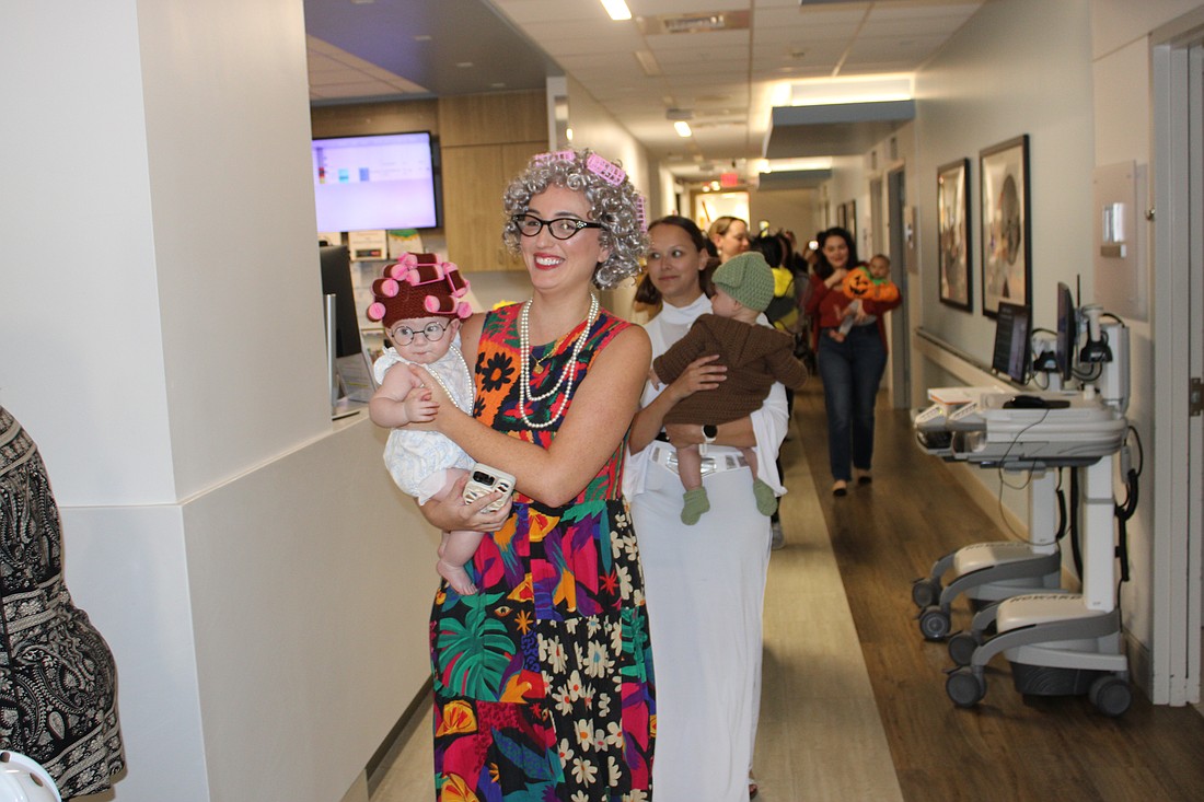 Sweetwater's Monica Zacour and 5-month-old Everly curl through the parade route at Lakewood Ranch Medical Center Oct. 29.