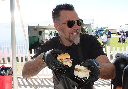 Evan Percoco, co-owner of Twisted Pit BBQ of Lakewood Ranch, dishes out samples at the Rotary Club of Lakewood Ranch's Suncoast Food and Wine Fest, Nov. 1 at Premier Sports Campus.