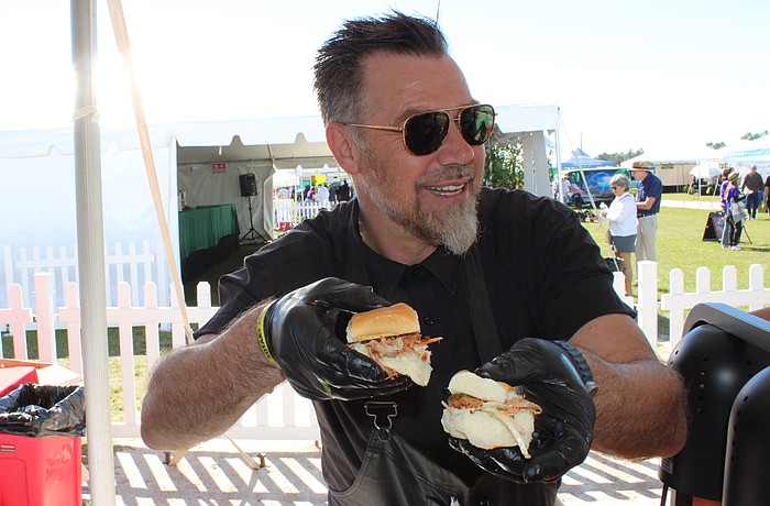 Evan Percoco, co-owner of Twisted Pit BBQ of Lakewood Ranch, dishes out samples at the Rotary Club of Lakewood Ranch's Suncoast Food and Wine Fest, Nov. 1 at Premier Sports Campus.