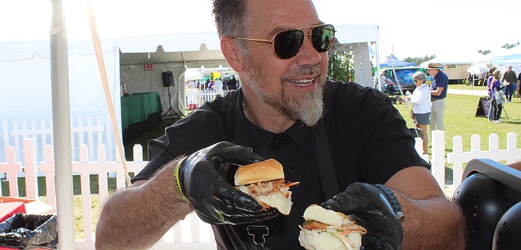 Evan Percoco, co-owner of Twisted Pit BBQ of Lakewood Ranch, dishes out samples at the Rotary Club of Lakewood Ranch's Suncoast Food and Wine Fest, Nov. 1 at Premier Sports Campus.