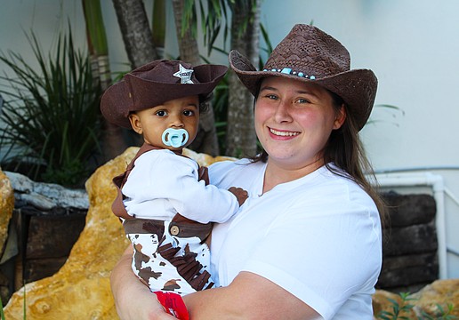 Tiffany Ranieri and 10-month-old Eli White patrol for mischief-makers during his first time trick-or-treating on Halloween at Fright Night on St. Armands Circle.