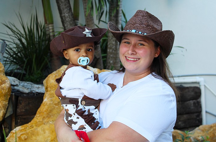 Tiffany Ranieri and 10-month-old Eli White patrol for mischief-makers during his first time trick-or-treating on Halloween at Fright Night on St. Armands Circle.