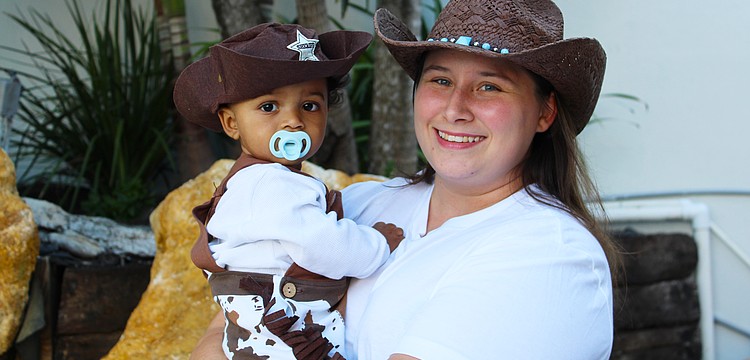 Tiffany Ranieri and 10-month-old Eli White patrol for mischief-makers during his first time trick-or-treating on Halloween at Fright Night on St. Armands Circle.