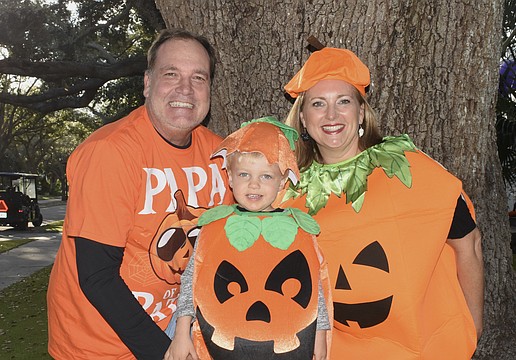 Andre Herke, Thomas Herke, 3, and Jennifer Herke dressed as pumpkins.