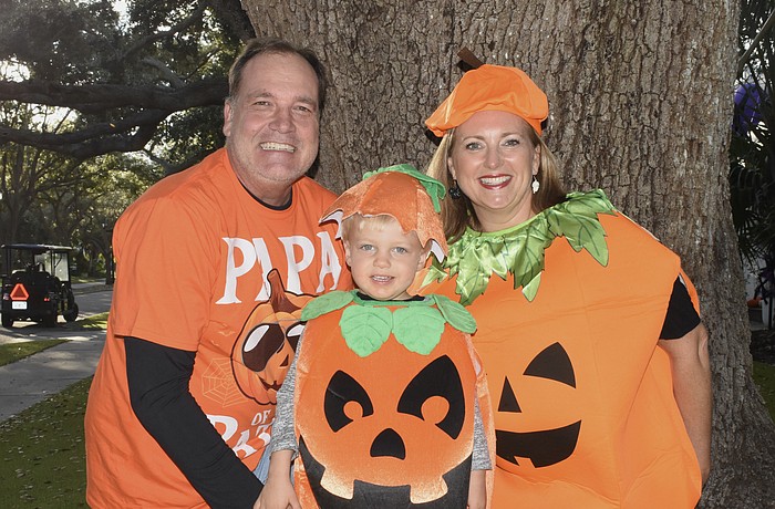 Andre Herke, Thomas Herke, 3, and Jennifer Herke dressed as pumpkins.