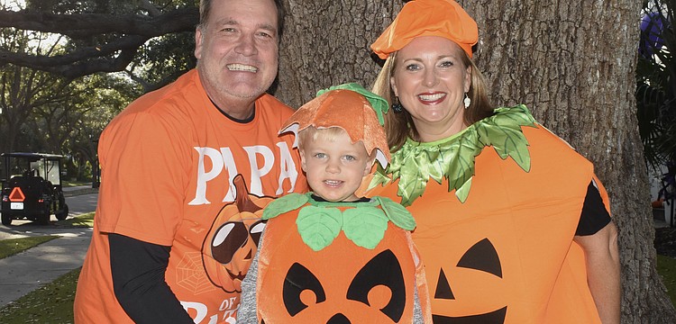 Andre Herke, Thomas Herke, 3, and Jennifer Herke dressed as pumpkins.