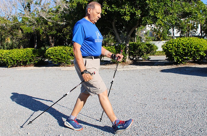 Enrico “Sam” DiGiammarino, Jr. demonstrates the proper technique for Nordic walking, which distributes weight through the arms to a pair of walking poles. As a trained instructor, he leads classes with several local organizations.
