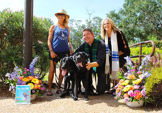 Diane Weisman brings her black Labrador retrievers to join an interfaith pet blessing from Rev. David Marshall of All Angels by the Sea Episcopal Church and Rabbi Jessica Spitalnic Mates of Temple Beth Israel of Longboat Key on Oct. 26.