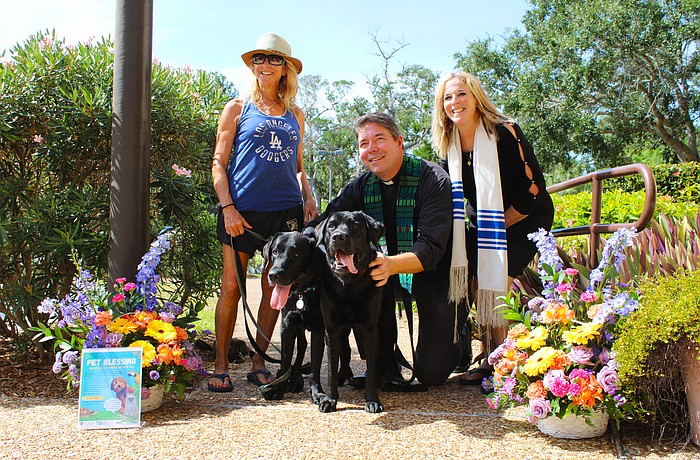 Diane Weisman brings her black Labrador retrievers to join an interfaith pet blessing from Rev. David Marshall of All Angels by the Sea Episcopal Church and Rabbi Jessica Spitalnic Mates of Temple Beth Israel of Longboat Key on Oct. 26.