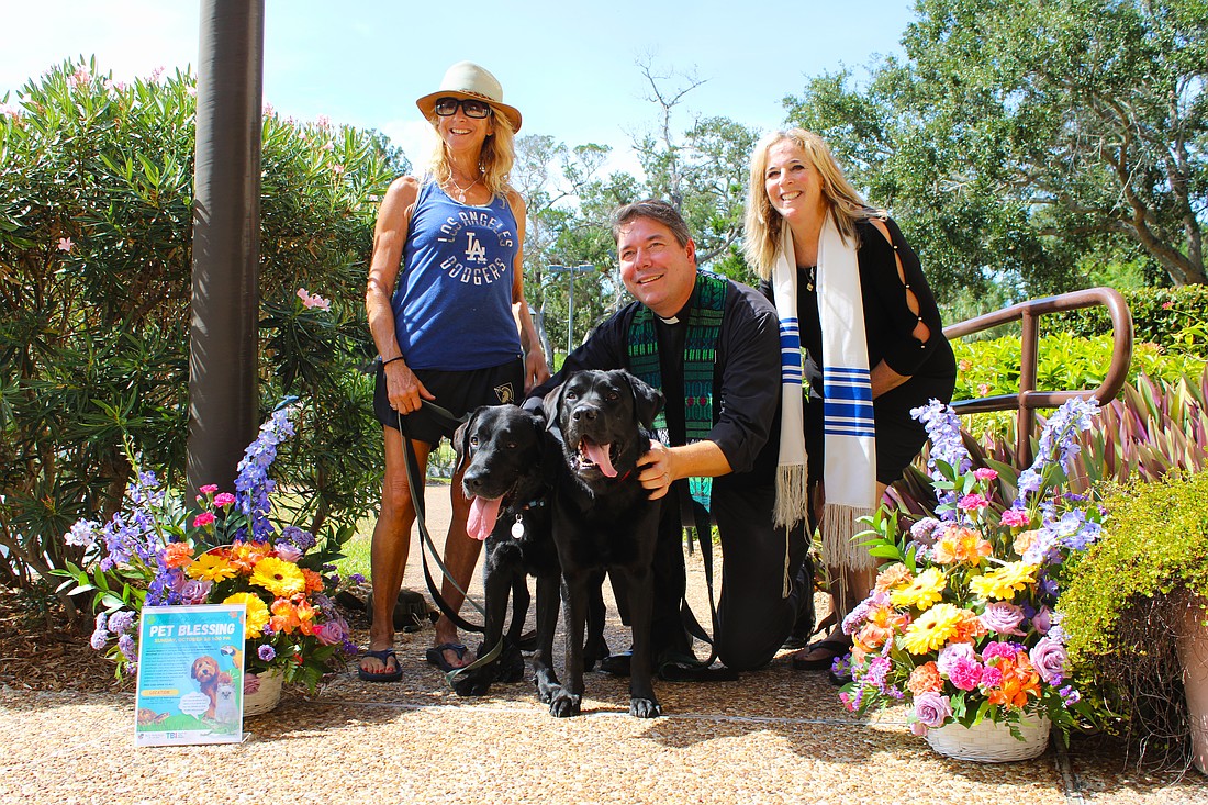 Diane Weisman brings her black Labrador retrievers to join an interfaith pet blessing from Rev. David Marshall of All Angels by the Sea Episcopal Church and Rabbi Jessica Spitalnic Mates of Temple Beth Israel of Longboat Key on Oct. 26.