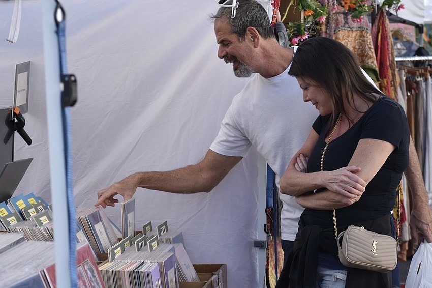 Matt and Beth Procaccini browse the artwork on display.