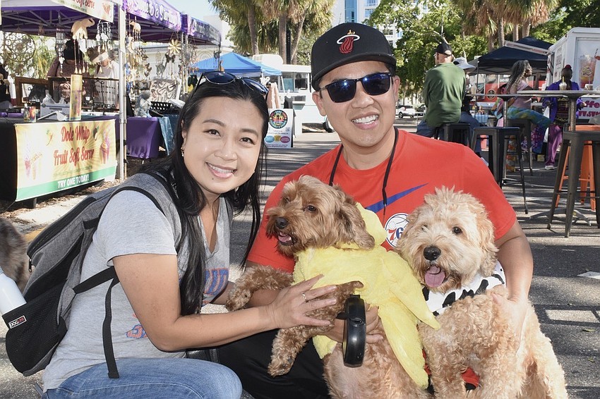 Rose Le and her husband Steve Taz hold their mini doodles Sara and Soda.
