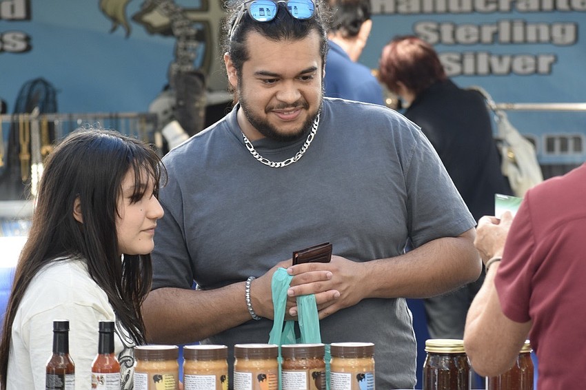 Kat Loaisiga, 12, and her brother Walter Espinoza, shop at the market.