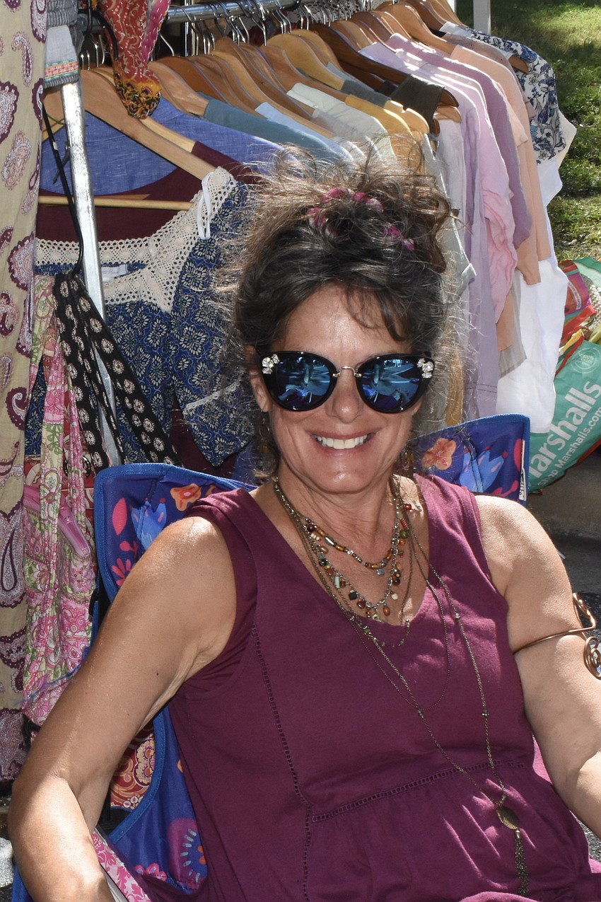 Angie Resnick of Wildflowers Boho Chic Boutique sits outside.