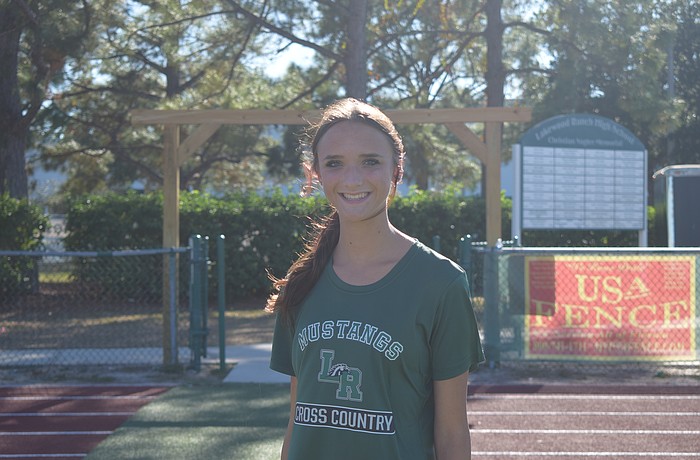 Addison Shear poses for a photo on Nov. 3 before a Lakewood Ranch girls' cross country practice. The junior broke her 5K personal record by 54 seconds at the Tri-County Championships on Nov. 1.