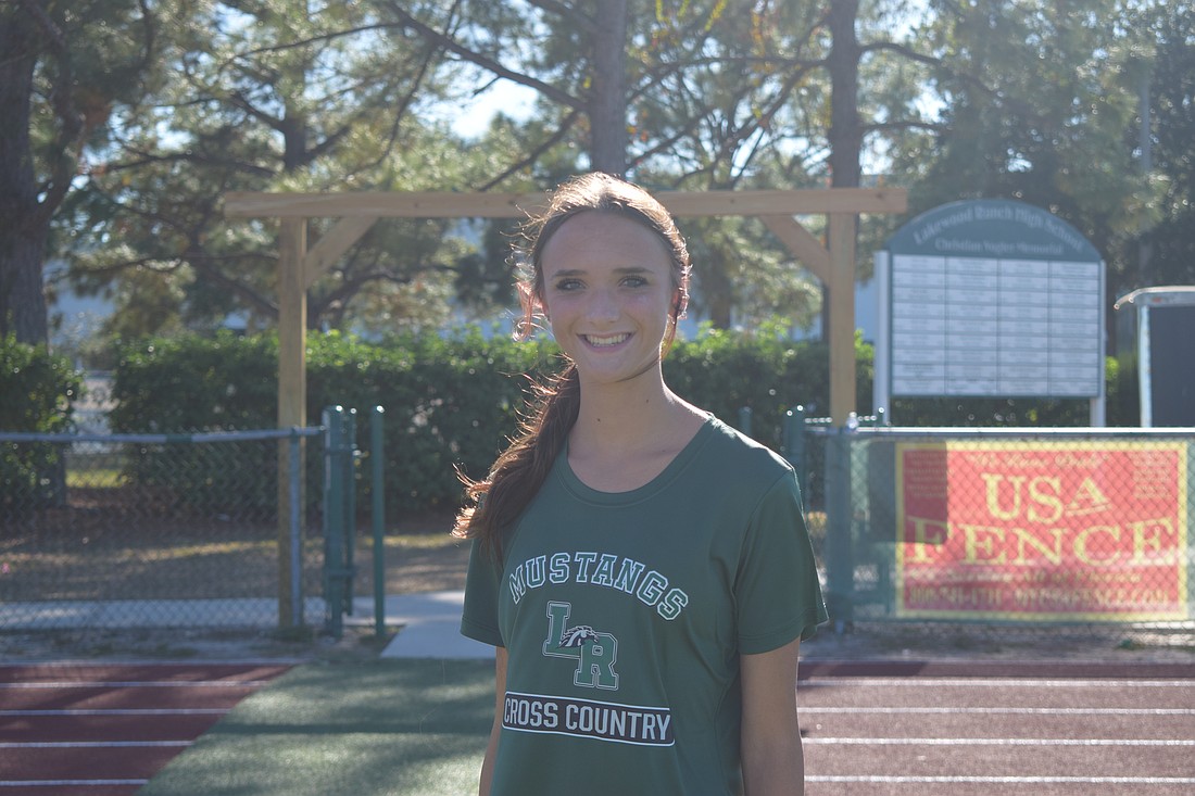 Addison Shear poses for a photo on Nov. 3 before a Lakewood Ranch girls' cross country practice. The junior broke her 5K personal record by 54 seconds at the Tri-County Championships on Nov. 1.