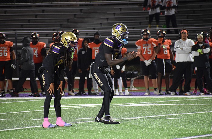 Joel Morris (center) prepares to receive the snap alongside senior running back/safety Jacobey Mobley (left). The senior quarterback threw for 23 touchdowns and 1,803 yards with no interceptions during the 2025 regular season.