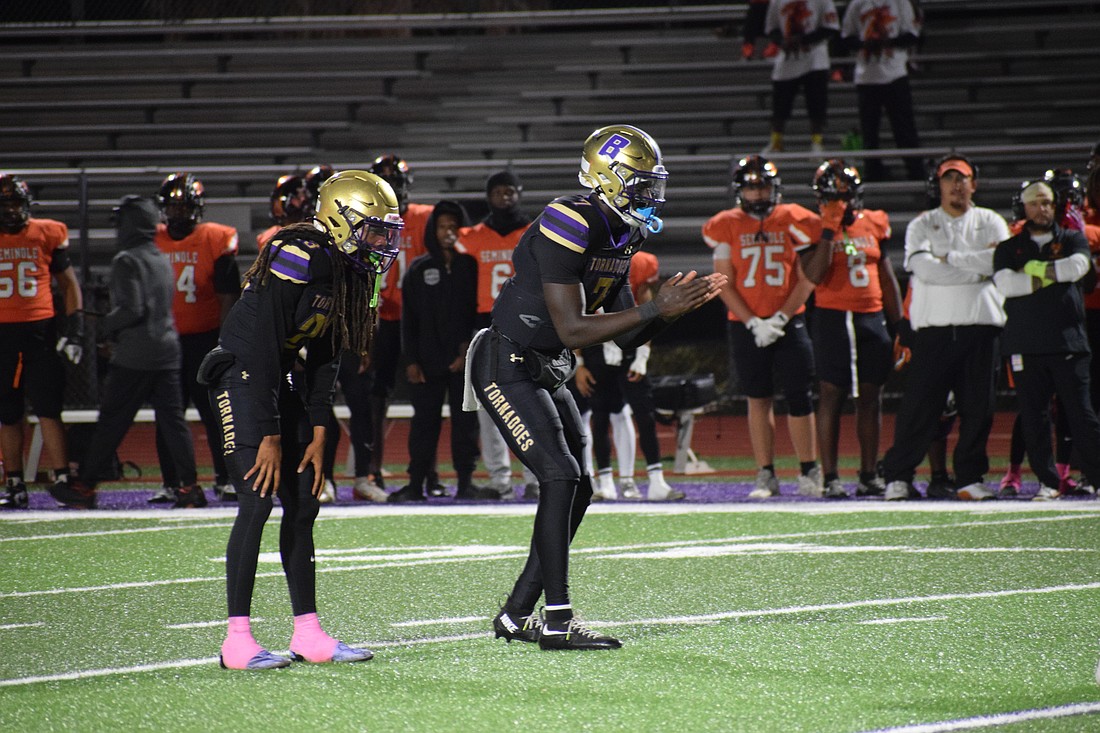 Joel Morris (center) prepares to receive the snap alongside senior running back/safety Jacobey Mobley (left). The senior quarterback threw for 23 touchdowns and 1,803 yards with no interceptions during the 2025 regular season.