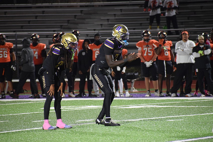Joel Morris (center) prepares to receive the snap alongside senior running back/safety Jacobey Mobley (left). The senior quarterback threw for 23 touchdowns and 1,803 yards with no interceptions during the 2025 regular season.