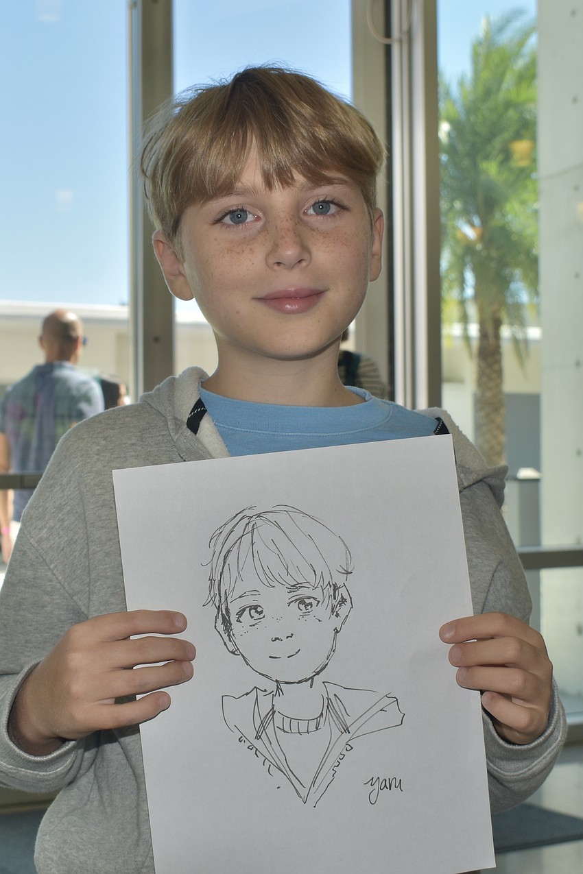 Kai Molina-Nash, 9, had his picture drawn by Julia Zhao, a senior at Pine View School.